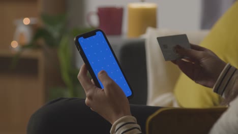 Close-Up-Of-Woman-At-Home-Shopping-Online-With-Credit-Card-Using-green-screen,-blue-Screen-Mobile-Phone