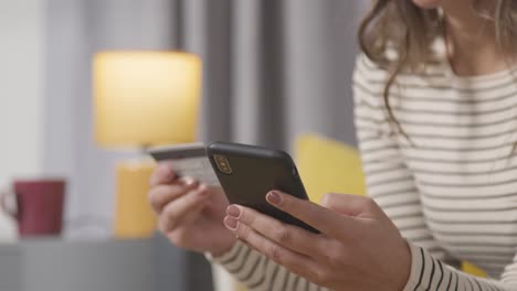 Close-Up-Of-Woman-At-Home-Shopping-Online-With-Credit-Card-Using-Mobile-Phone-2