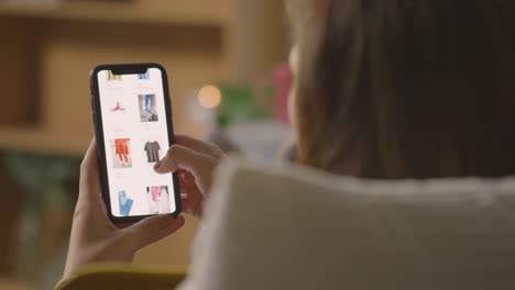 Close-Up-Of-Woman-At-Home-Shopping-Online-For-Clothes-Using-Mobile-Phone-4