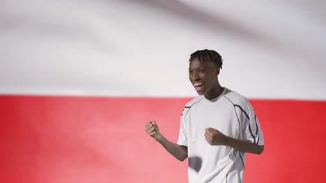 Young-Footballer-Celebrating-to-Camera-In-Front-of-Poland-Flag-02