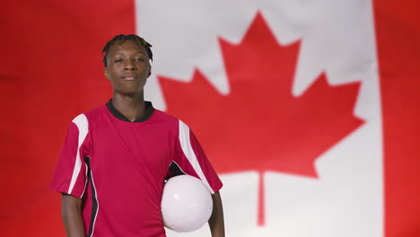 Joven-Futbolista-Posando-Frente-A-La-Bandera-De-Canadá-01