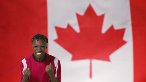 Young-Footballer-Celebrating-to-Camera-In-Front-of-Canada-Flag-01