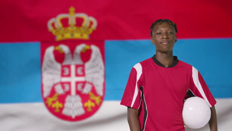 Young-Footballer-Posing-In-Front-of-Serbia-Flag-01