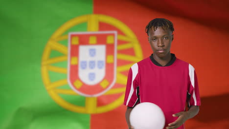 Young-Footballer-Posing-In-Front-of-Portugal-Flag-01