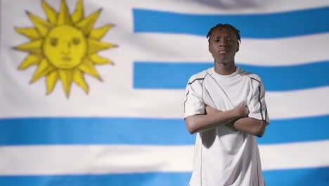 Young-Footballer-Posing-In-Front-of-Uruguay-Flag-01
