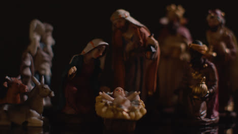 Studio-Christmas-Concept-Of-Baby-Jesus-In-Manger-With-Figures-From-Nativity-Scene-