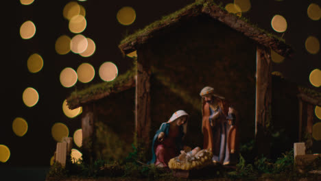 Studio-Christmas-Scene-With-Figures-Of-Mary-Joseph-And-Baby-Jesus-In-Manger-From-Nativity-With-Lights