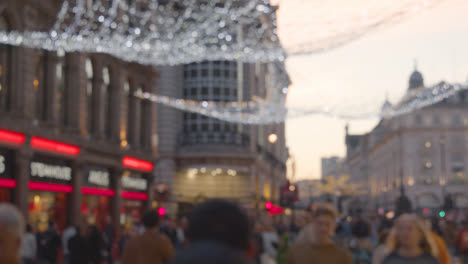 Tiro-Desenfocado-De-Luces-Y-Adornos-Navideños-Fuera-De-Las-Tiendas-Cerca-De-Leicester-Square-En-Londres,-Reino-Unido