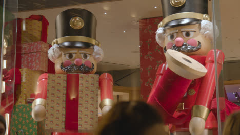 Shoppers-On-London-UK-Regent-Street-Walk-Past-Hamley's-Toy-Store-Window-Display-At-Night