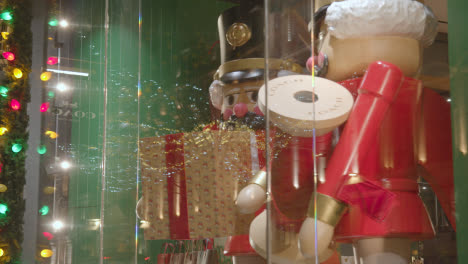 Shoppers-On-London-UK-Regent-Street-Walk-Past-Hamley's-Toy-Store-Window-Display-At-Night-2