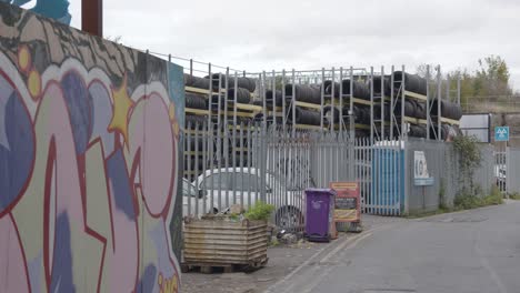 Garage-Selling-Car-Tyres-In-Inner-City-London-With-Graffiti-Covered-Walls-In-London-UK