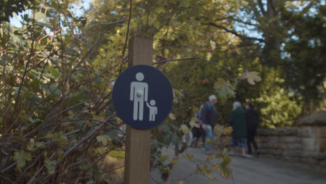 Sign-Warning-Of-Parents-With-Children-On-Bridge-In-Arboretum