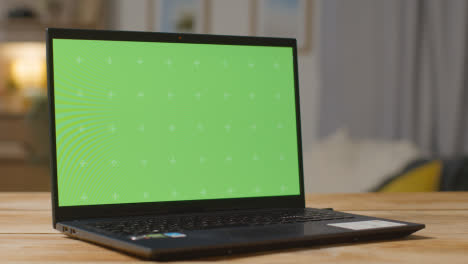 Green-Screen-Laptop-On-Table-At-Home