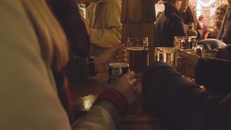 Close-Up-Of-People-Drinking-Beer-And-Gluhwein-At-Frankfurt-Christmas-Market-Stalls-In-Birmingham-UK-At-Night