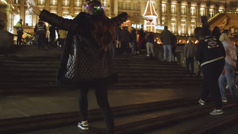 Woman-Visiting-Frankfurt-Christmas-Market-In-Victoria-Square-Birmingham-UK-At-Night