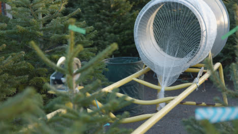 Machine-For-Netting-Christmas-Trees-Outdoors-At-Garden-Centre-4