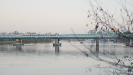 Fulham-Rail-Bridge-With-Train-Crossing-Over-River-Thames-In-London-In-Winter