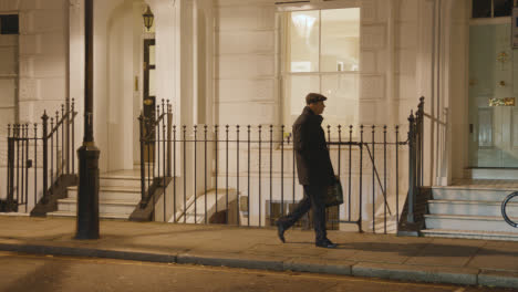 Man-Walking-Past-Exclusive-Luxury-Housing-In-Belgrave-Square-London-At-Night