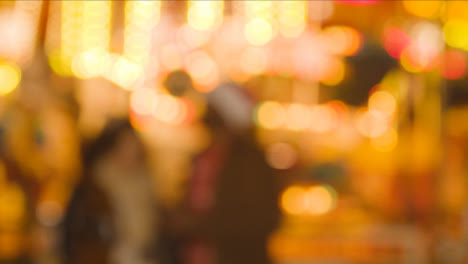 Defocused-Shot-Of-Lights-On-Fairground-Roundabout-On-London-South-Bank-At-Night-