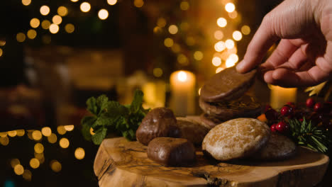 Christmas-Food-At-Home-And-Person-Picking-Up-Traditional-German-Christmas-Lebkuchen