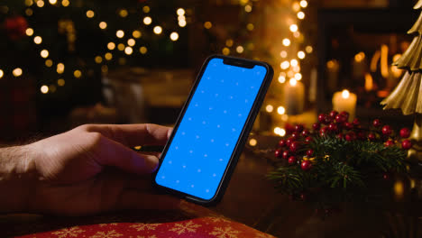 Christmas-At-Home-With-Person-Using-Blue-Screen-Mobile-Phone