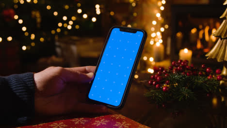 Christmas-At-Home-With-Person-Using-Blue-Screen-Mobile-Phone-1