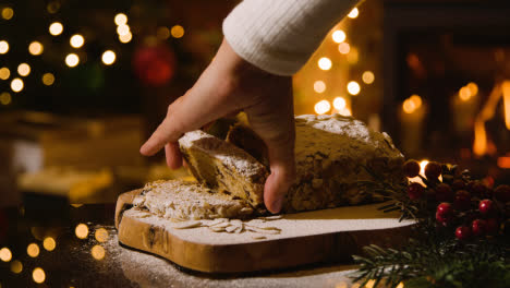 Christmas-Food-At-Home-And-Person-Picking-Up-Traditional-Stollen-Cake-On-Table