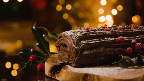 Christmas-Food-At-Home-And-Traditional-Yule-Log-Dusted-With-Icing-Sugar-On-Table-1