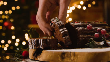 Christmas-Food-At-Home-And-Person-Picking-Up-Slice-Of-Yule-Log