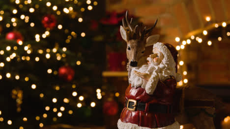 Close-Up-Of-Christmas-Decoration-Of-Santa-With-Rudolph-At-Home-Tree-And-Lights-1