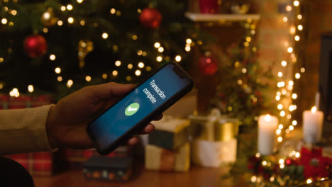 Christmas-At-Home-With-Person-Making-Card-Purchase-On-Mobile-Phone