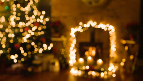 Defocused-Shot-Of-Christmas-At-Home-With-Presents-Around-Tree-Fire-And-Candles-1