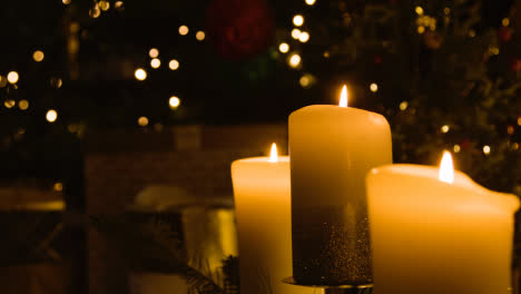 Close-Up-Of-Candles-By-Christmas-Tree-At-Home