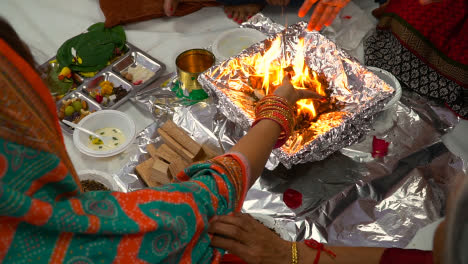 Close-Up-Of-Worshippers-Offer-Smaghri-Into-Fire-In-Havan-Ceremony-For-Navratri-1