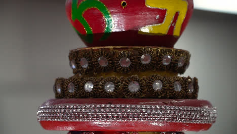 Close-Up-Of-Turning-Hindu-Lamp-With-Om-And-Swastika-Symbols-During-Havan-Ceremony