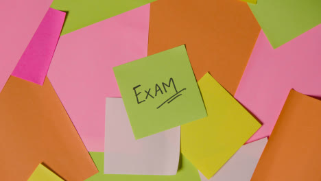 Education-Concept-Of-Revolving-Sticky-Notes-With-Exam-Written-On-Top-Note