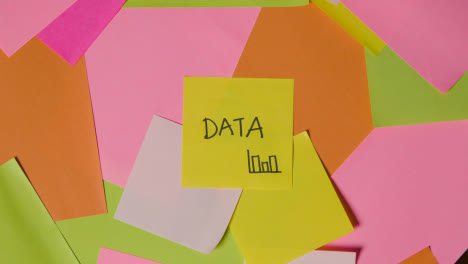 Business-Concept-Of-Revolving-Sticky-Notes-With-Data-Written-On-Top-Note