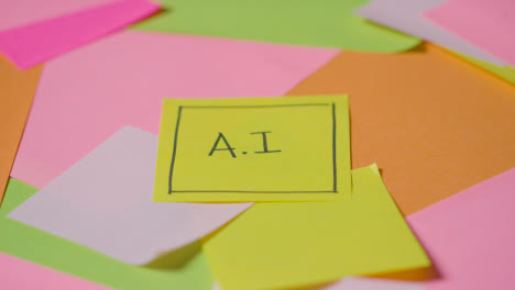 Business-Concept-Of-Revolving-Sticky-Notes-With-AI-Written-On-Top-Note-1