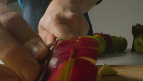Close-Up-Of-Man-Cutting-Fresh-Apples-On-Chopping-Board-3
