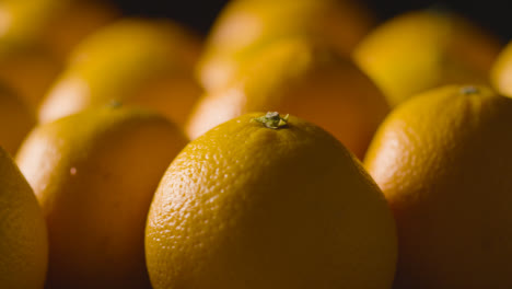 Close-Up-Studio-Shot-Of-Oranges-Revolving-Against-Black-Background