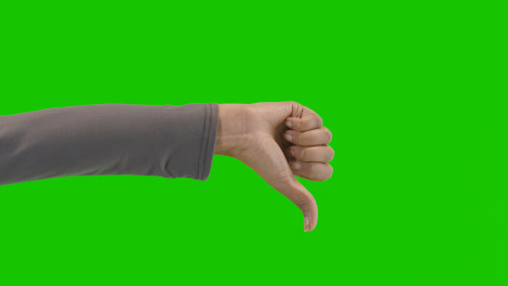 Studio-Close-Up-Shot-Of-Woman-Giving-Thumbs-Down-Sign-Against-Green-Screen-1