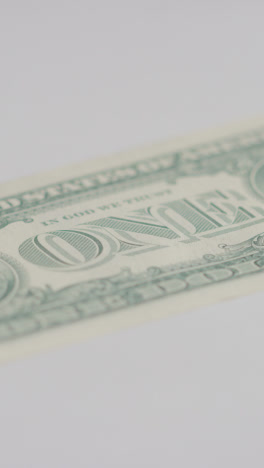 Vertical-Video-Close-Up-Currency-Shot-Of-Hand-Grabbing-US-1-Dollar-Bill-On-Marble-Background