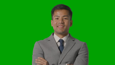 Portrait-Of-Businessman-In-Suit-Against-Green-Screen-Smiling-At-Camera-1