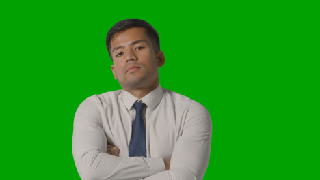 Portrait-Of-Serious-Businessman-In-Shirt-And-Tie-Against-Green-Screen-Looking-At-Camera-