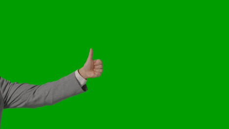 Close-Up-Of-Arm-Of-Businessman-In-Suit-Giving-Thumbs-Up-Gesture-Against-Green-Screen-