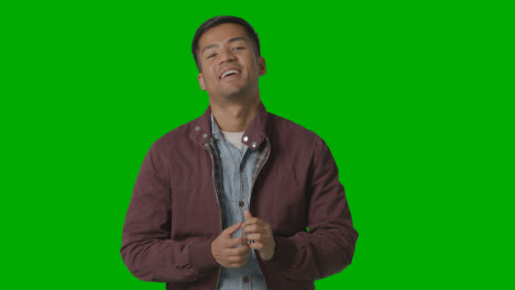 Portrait-Of-Casually-Dressed-Smiling-Young-Man-Against-Green-Screen-2