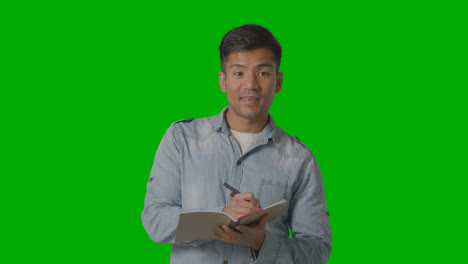 Male-Teacher-Talking-To-School-University-Or-College-Class-In-Lesson-Against-Green-Screen-1