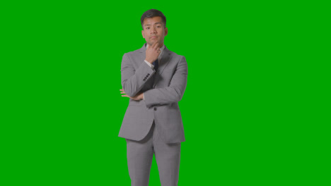 Three-Quarter-Length-Shot-Of-Serious-Businessman-In-Suit-Thinking-Against-Green-Screen-3
