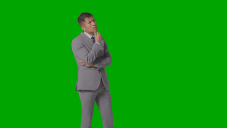 Three-Quarter-Length-Shot-Of-Serious-Businessman-In-Suit-Thinking-Against-Green-Screen-1