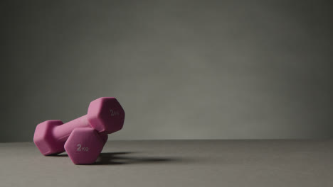 Fitness-Studio-Shot-Of-Exercise-Dumbbell-Weights-Against-Grey-Background-2